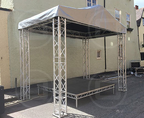 Small covered stage for street event.