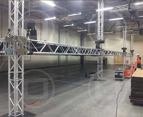 Ground support truss as part of a set structure for a corporate party in a warehouse.